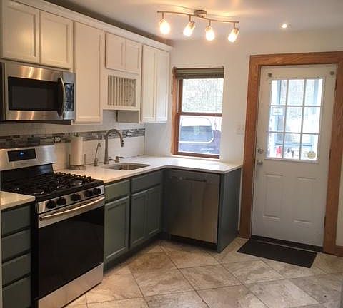 New kitchen with appliances and cabinetry