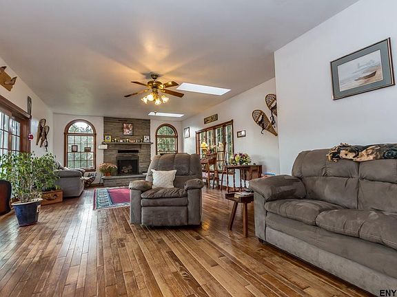 16' x 31'  Hardwood, stone wood-burning fireplace with blower, skylight, double doors to deck.