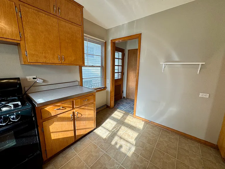 Kitchen leads to exterior side door, attached garage and full basement.