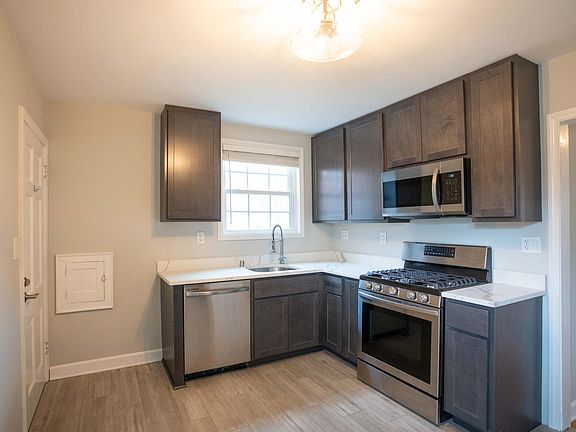 Kitchen features brand new stainless appliances with a gas range, dishwasher, and quartz counter tops.