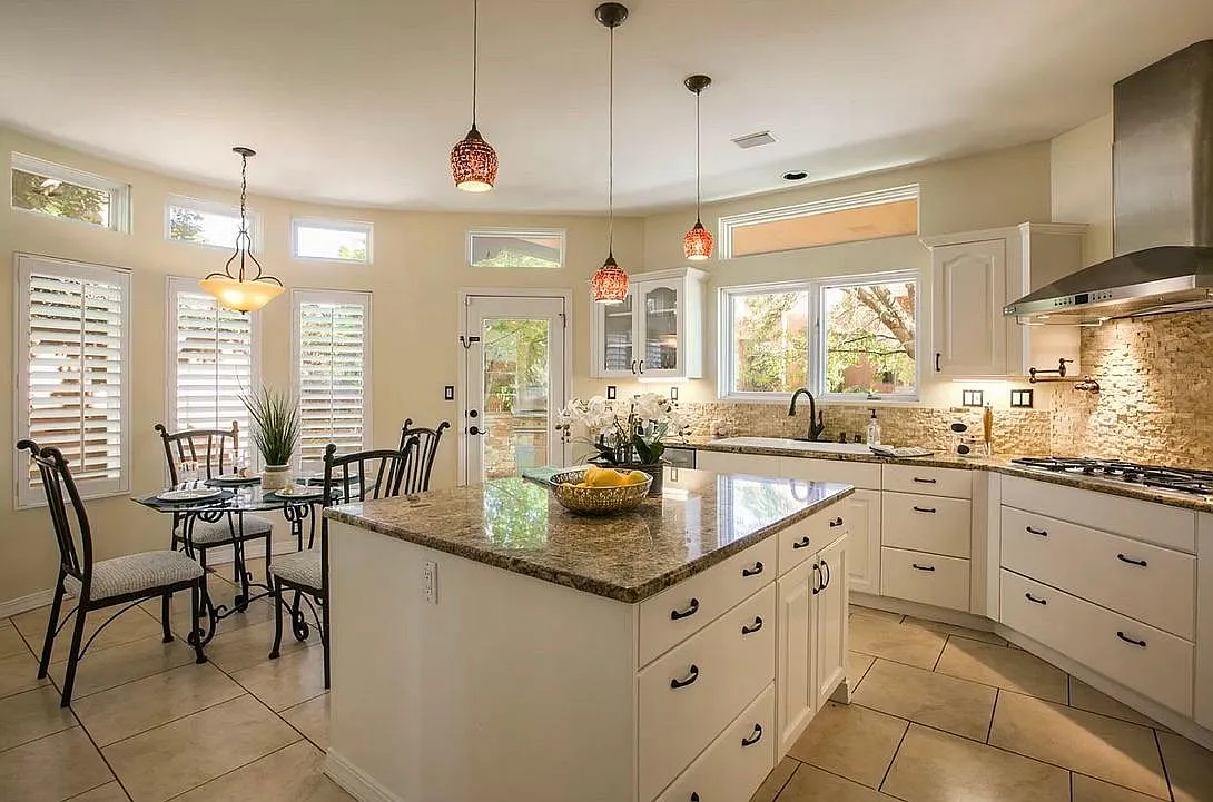 Large chef's kitchen. Large window at main sink. Dimmable LED lighting. Gas oven top with pot filler, over head stainless steel vented hood with LED lights. Door leading to custom BBQ grill. - 4301 Via De Luna NE