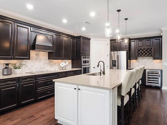 Thoughtfully designed kitchen with personalized upgrades, tile backsplash, Mostainless steel applian
