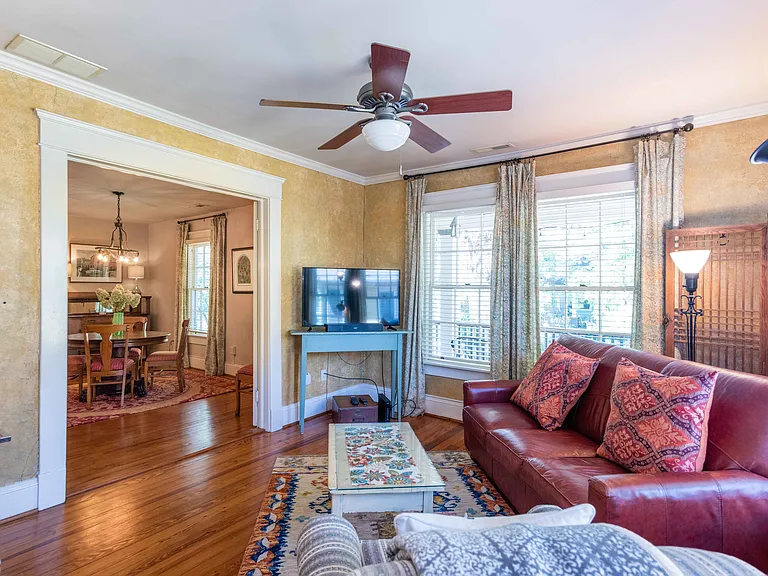 Living room
+TV
+Fireplace (non-functional)
+Large sofa
+Large windows