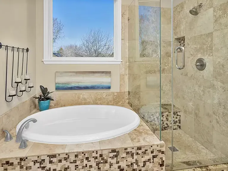Sunny master bathroom with walk-in closet