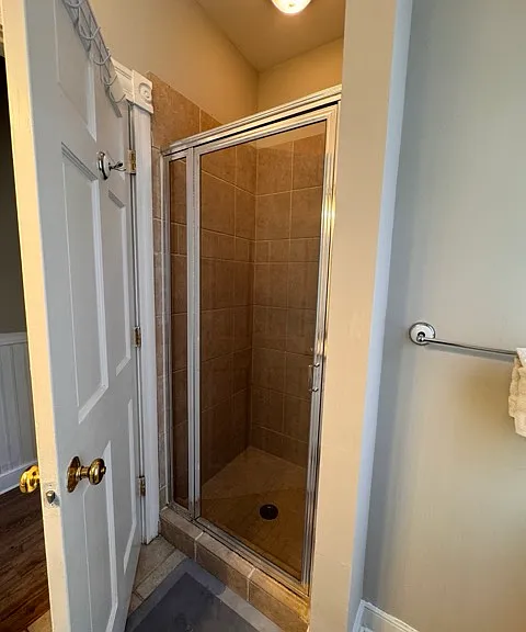 Upstairs bathroom shower behind the door.