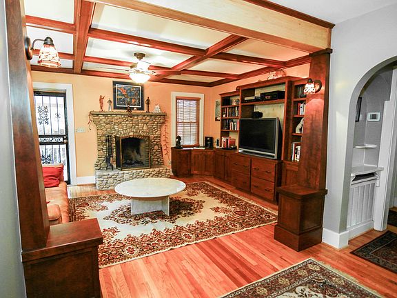 Living room includes built-in entertainment cabinets