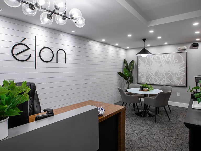 Step into our welcoming leasing office at Elon Winter Park Apartments. With modern decor, sleek design elements, and a comfortable meeting area, this space offers a warm and professional environment for residents and visitors alike.