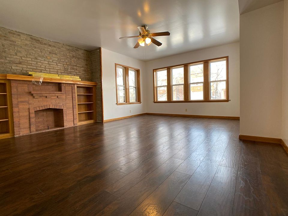 Large living room with decorative fireplace.