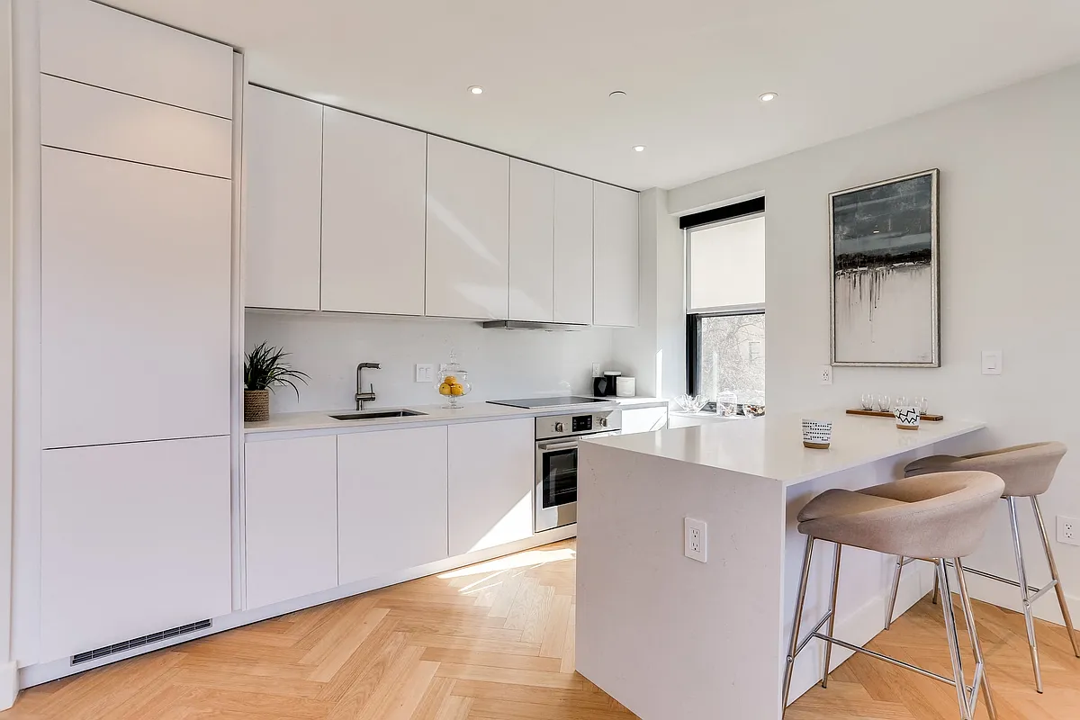Newly renovated kitchen with Quartz countertops and an integrated fridge and dishwasher - The Century