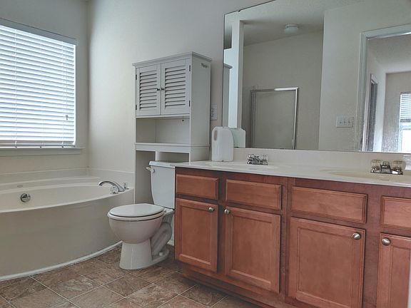 Master bathroom with tub and separate shower