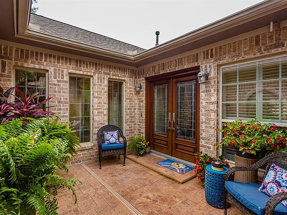The beautiful courtyard offers security, privacy and a gorgeous area that leads to the handsome double wood and leaded-glass front doors. What a beautiful way to welcome family and friends in to this fabulous home!