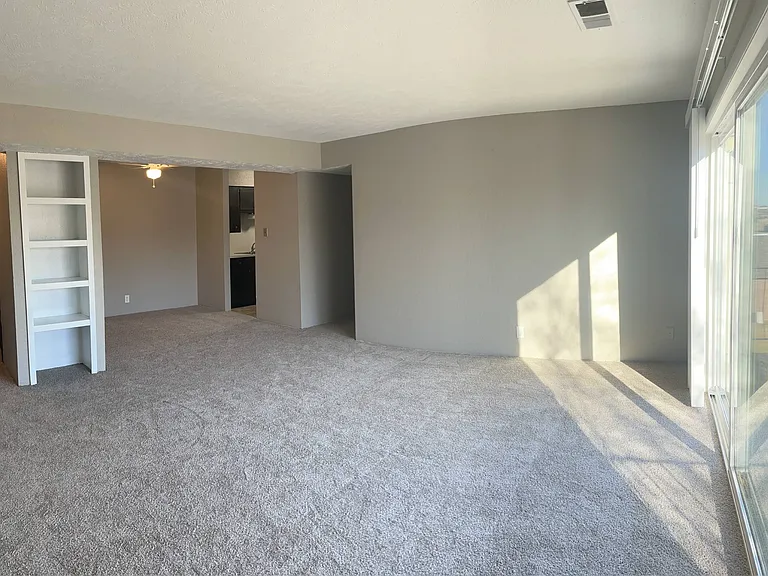 Large living room with built-in shelving at Whispering Isle.