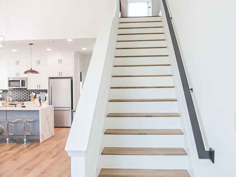 Stairs leading to primary main bedroom.