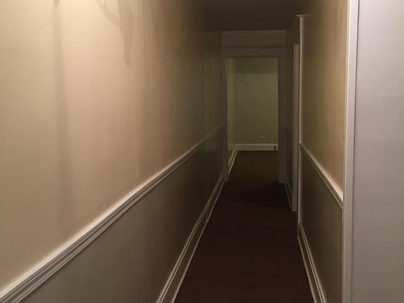The hallway leading to the family room and bedroom.