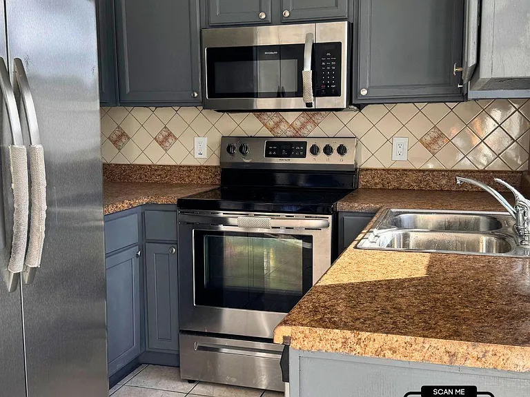 Renovated kitchen with stainless steel appliances in excellent condition.