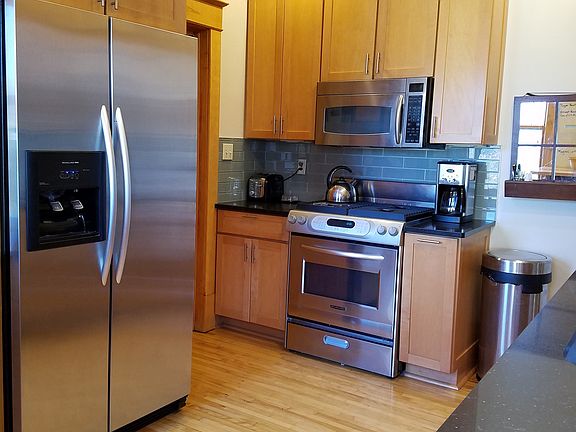 Ample kitchen with stainless appliances and quartz counterto