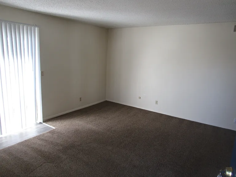 Living room leading to sliding glass door with balcony or patio