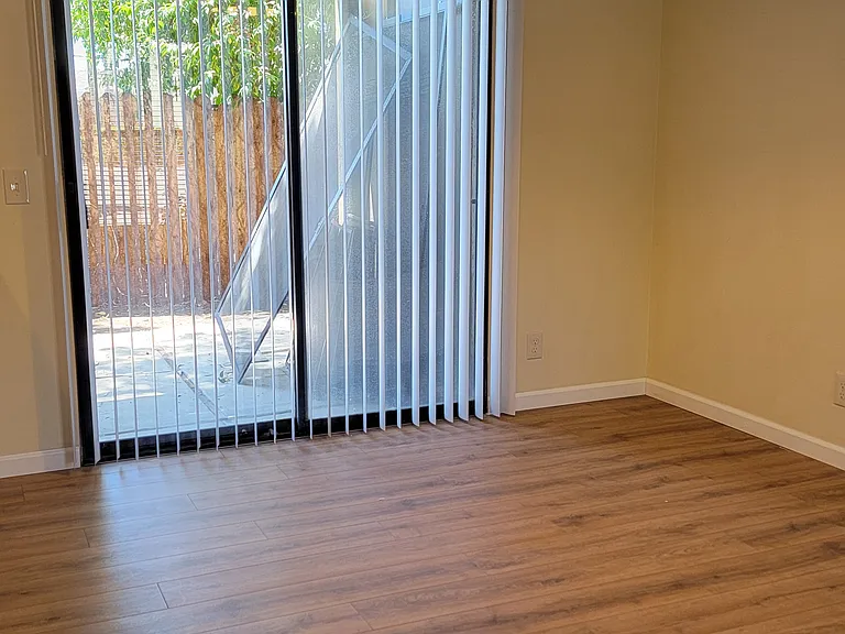 Unit F dining area leading to back yard patio