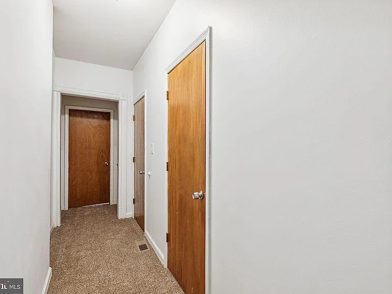 Corridor from living room to bedrooms and basement