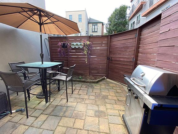 Fenced-in backyard with a locked gate