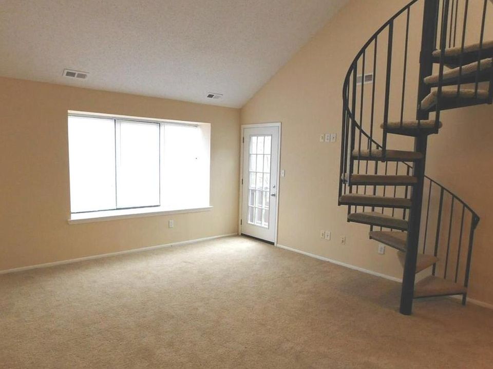 Spacious living room with access to balcony and loft