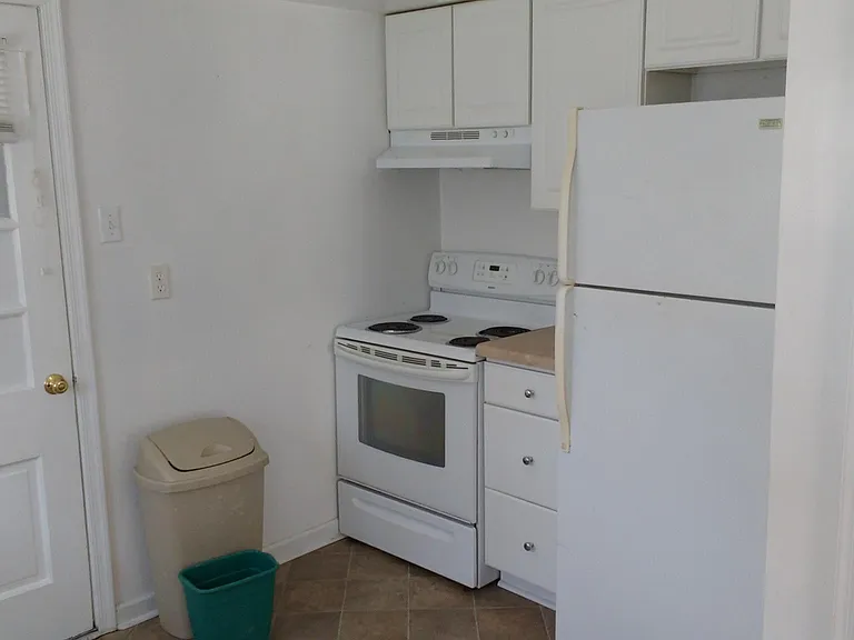 Kitchen stove and refrigerator, door to utility room
