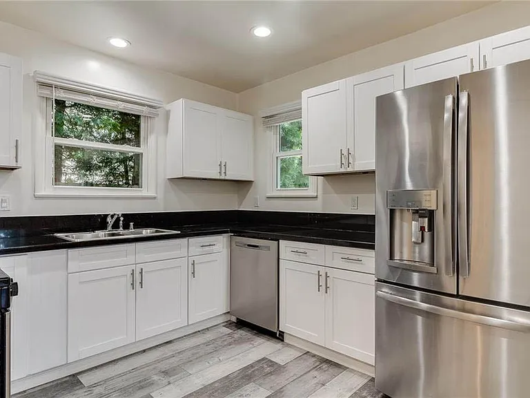 Beautifully updated kitchen with white shaker cabinetry, granite counters, brushed nickel pulls and handels, stainless appliances and more