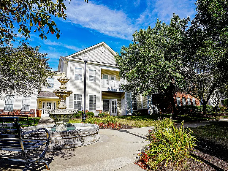 Where calm meets character: a gentle fountain flows in front of your beautifully designed apartment building.