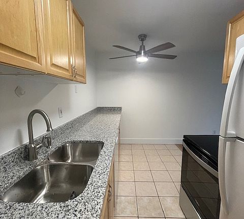 Kitchen with new quartz countertop and electric stove