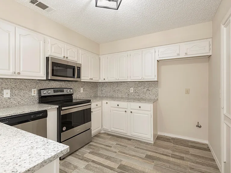 Kitchen does have stainless steel refrigerator.