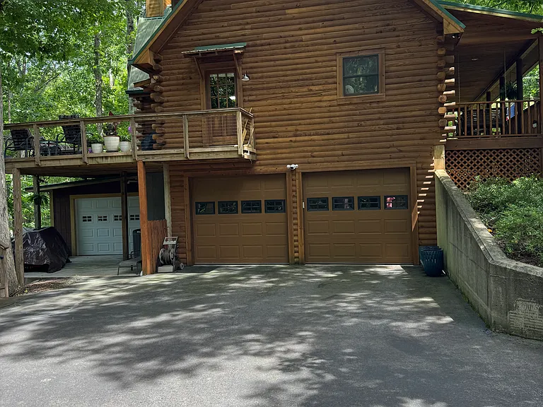 Two car garage and additional garage for storage of items. All 3 have garage door openers