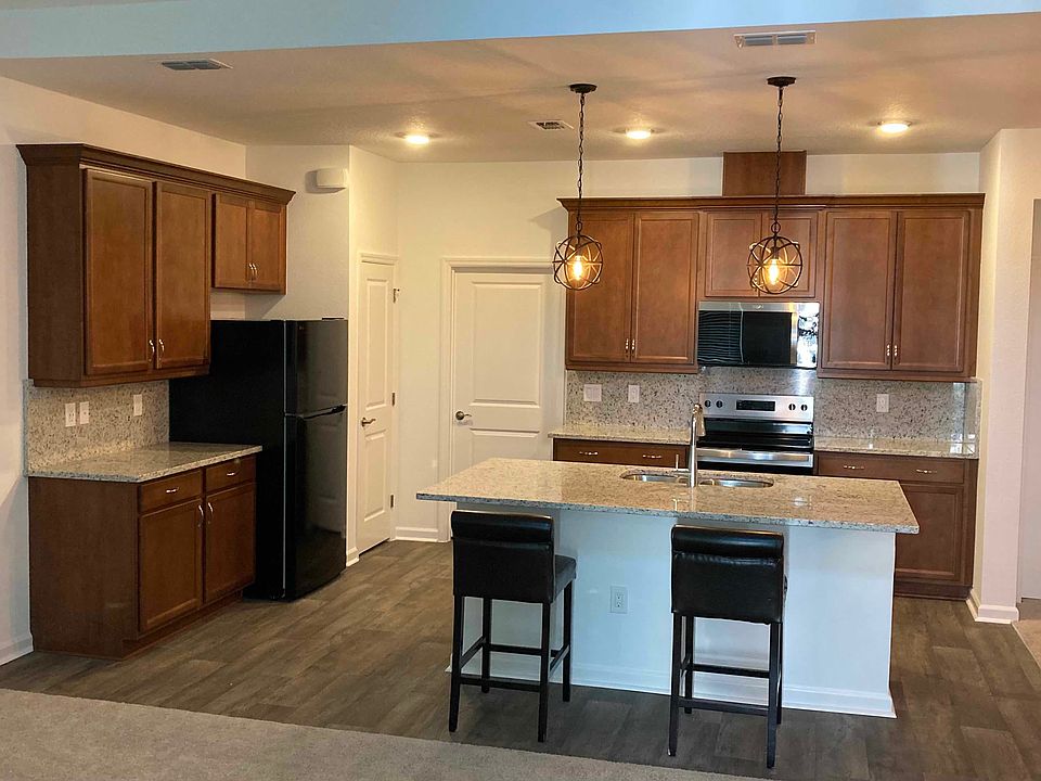 Open concept Living Room, Kitchen and Dining Room. View from Front Door in Foyer.