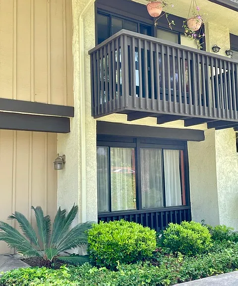 Townhouse facade with primary bedroom balcony
