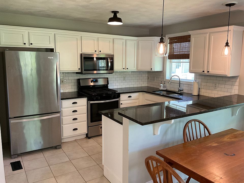Kitchen with space for bar stools and kitchen table.