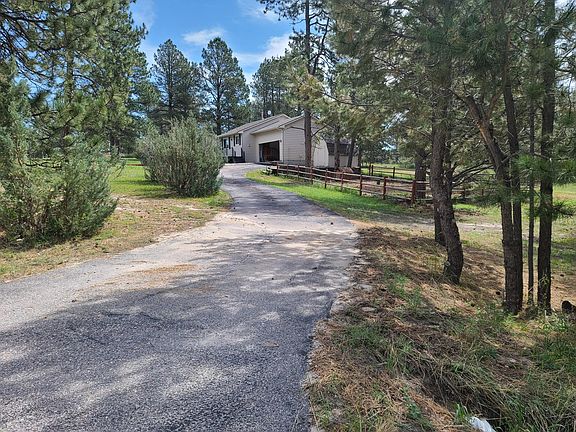 Drive next to fenced yard