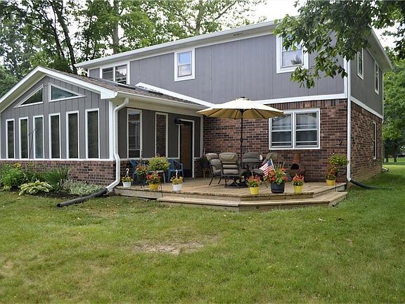 View of rear deck and Spa/Sunroom.  Great home for entertaining others or spoiling yourself! Room to romp & play.
