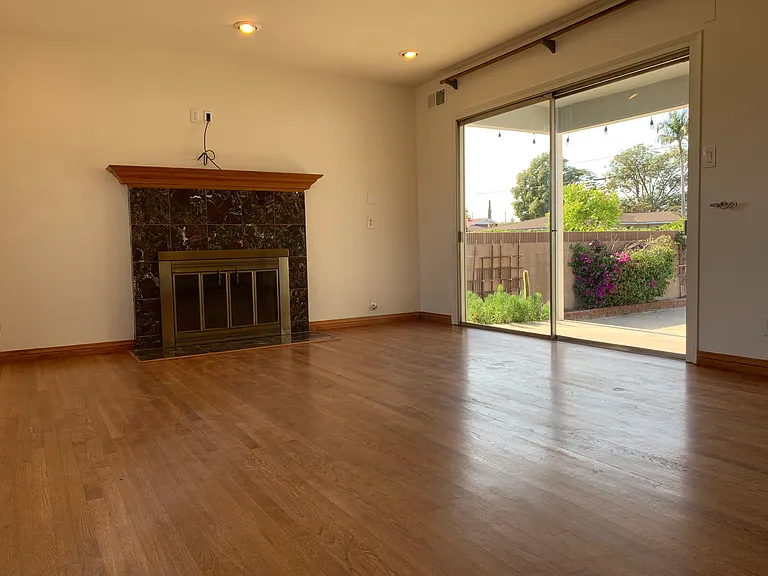 Living room with large sliding door, access to backyard