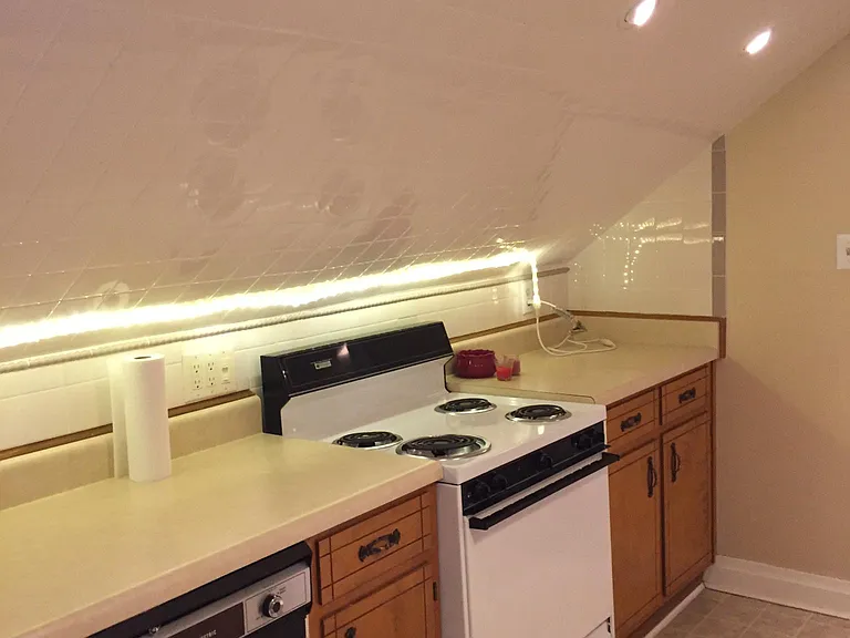 Appliance wall counters range cabinets and dishwasher, wall and ceiling lighting