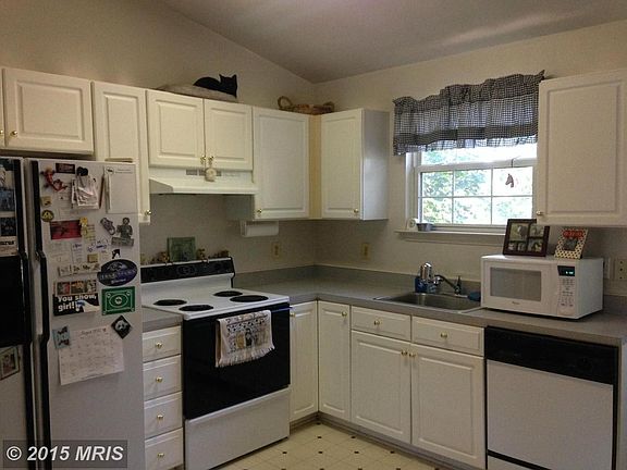 Bright and open kitchen with door to deck