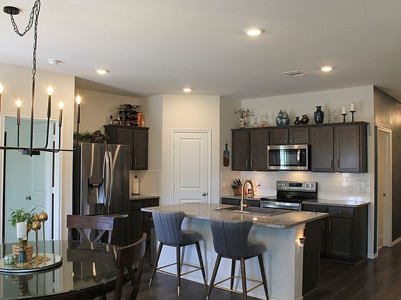 View of the kitchen, front door, and the breakfast area.