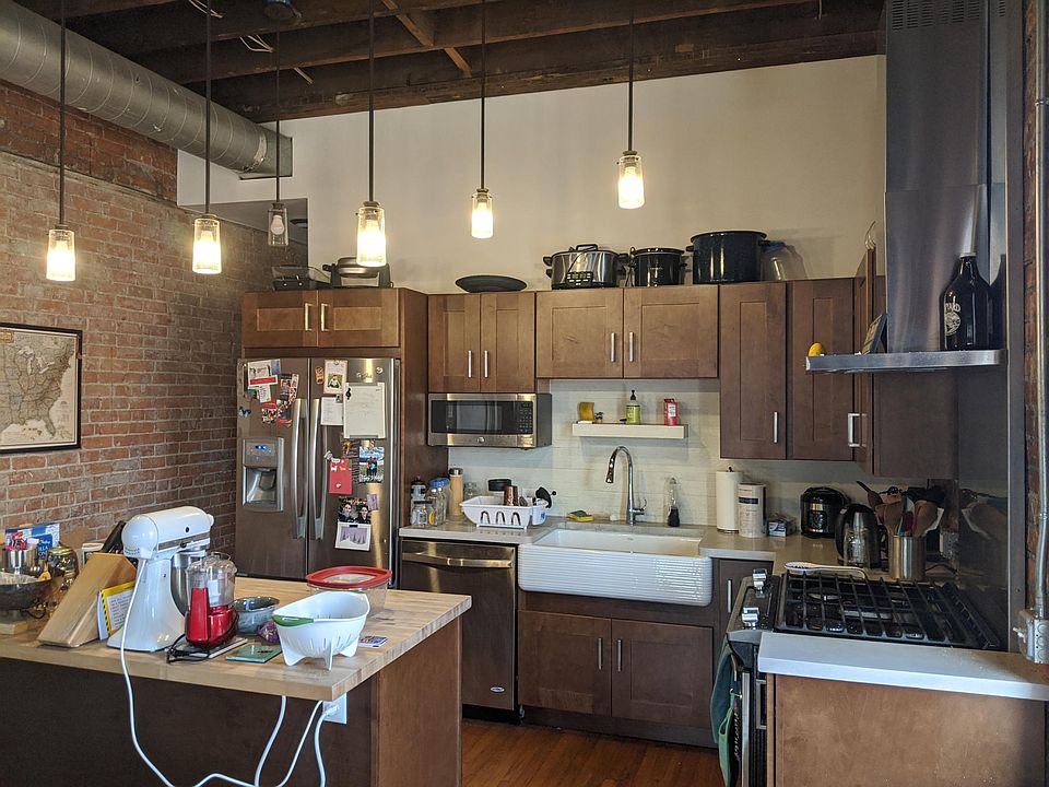 Stainless Steel appliances, concrete counters, butcher block island, farm sink, ample cabinet space