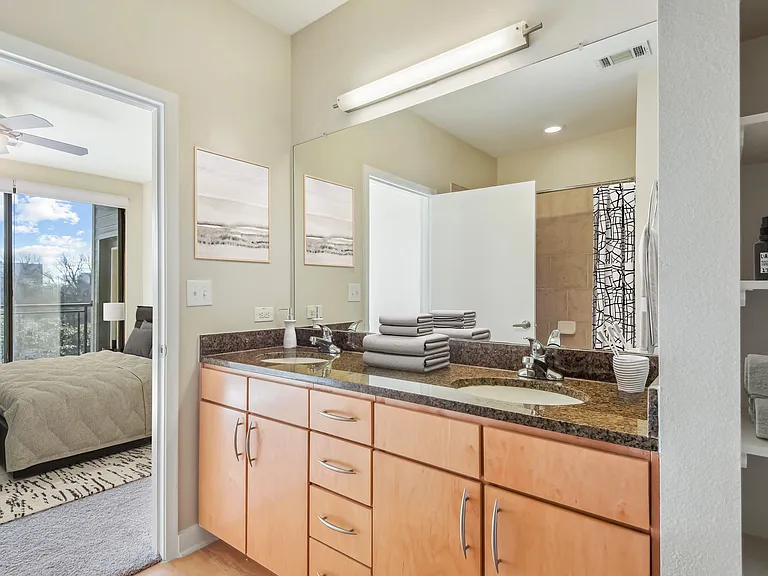 bathroom with storage and large mirror