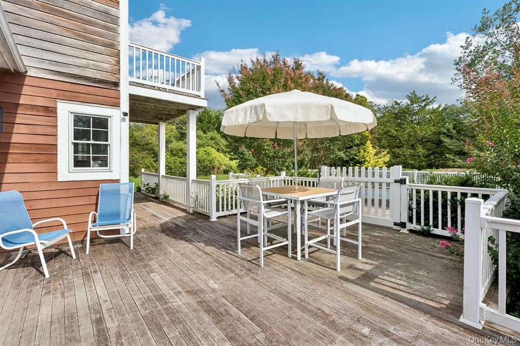 Expansive mahogany deck featuring an inviting outdoor dining area.