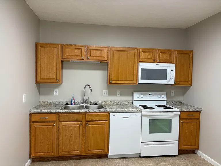 Kitchen with self-cleaning oven, dishwasher, garbage disposal and icemaker in freezer