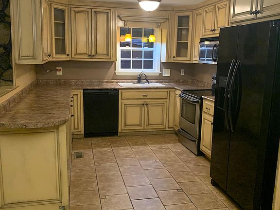 Kitchen with Stove, dishwasher and fridge.