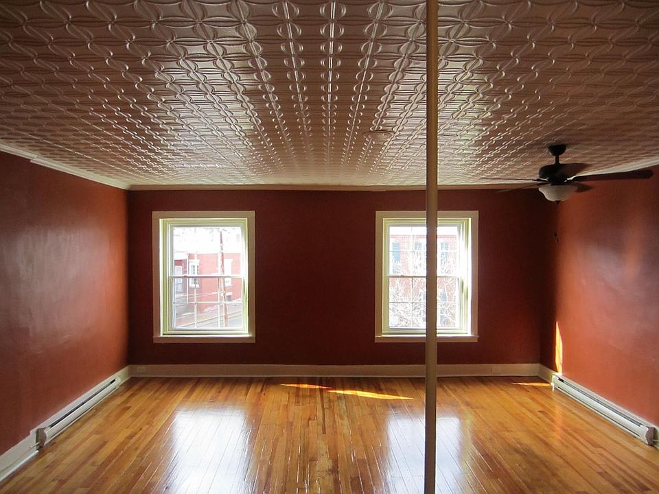 Large living room, tin ceilings, windows overlook downtown G