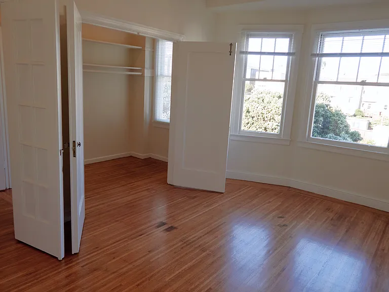 Bedroom with open Double Closet Doors