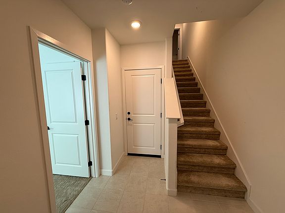 Front entryway. Room for rent on the left. Garage door straight ahead. Stairs up to living room and kitchen.