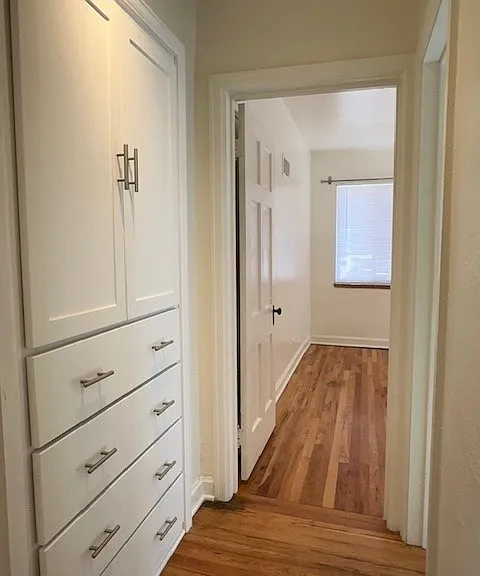 hallway with built-in storage
view into Bedroom #1