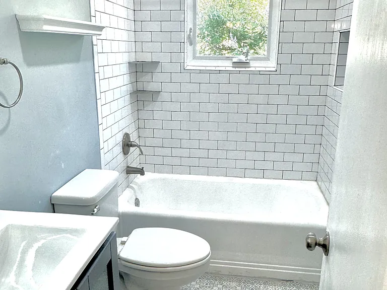 Bathroom with high-pressure shower head and roll-out/casement window.